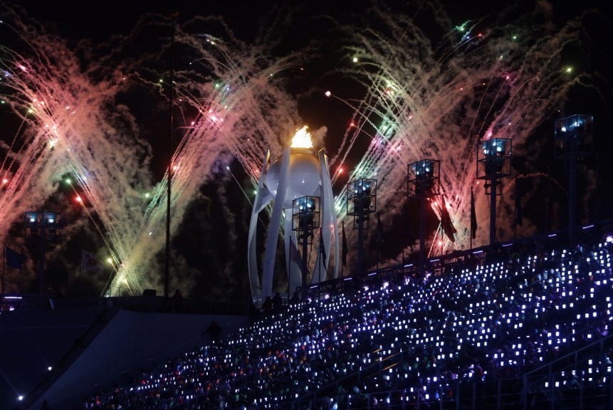 Fireworks explode over the Olympic flame during the closing ceremony of the 2018 Winter Olympics in Pyeongchang, South Korea, Sunday, Feb. 25, 2018. (AP Photo/Michael Probst)