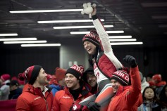 Alex Gough is picked up by teammates after winning Bronze