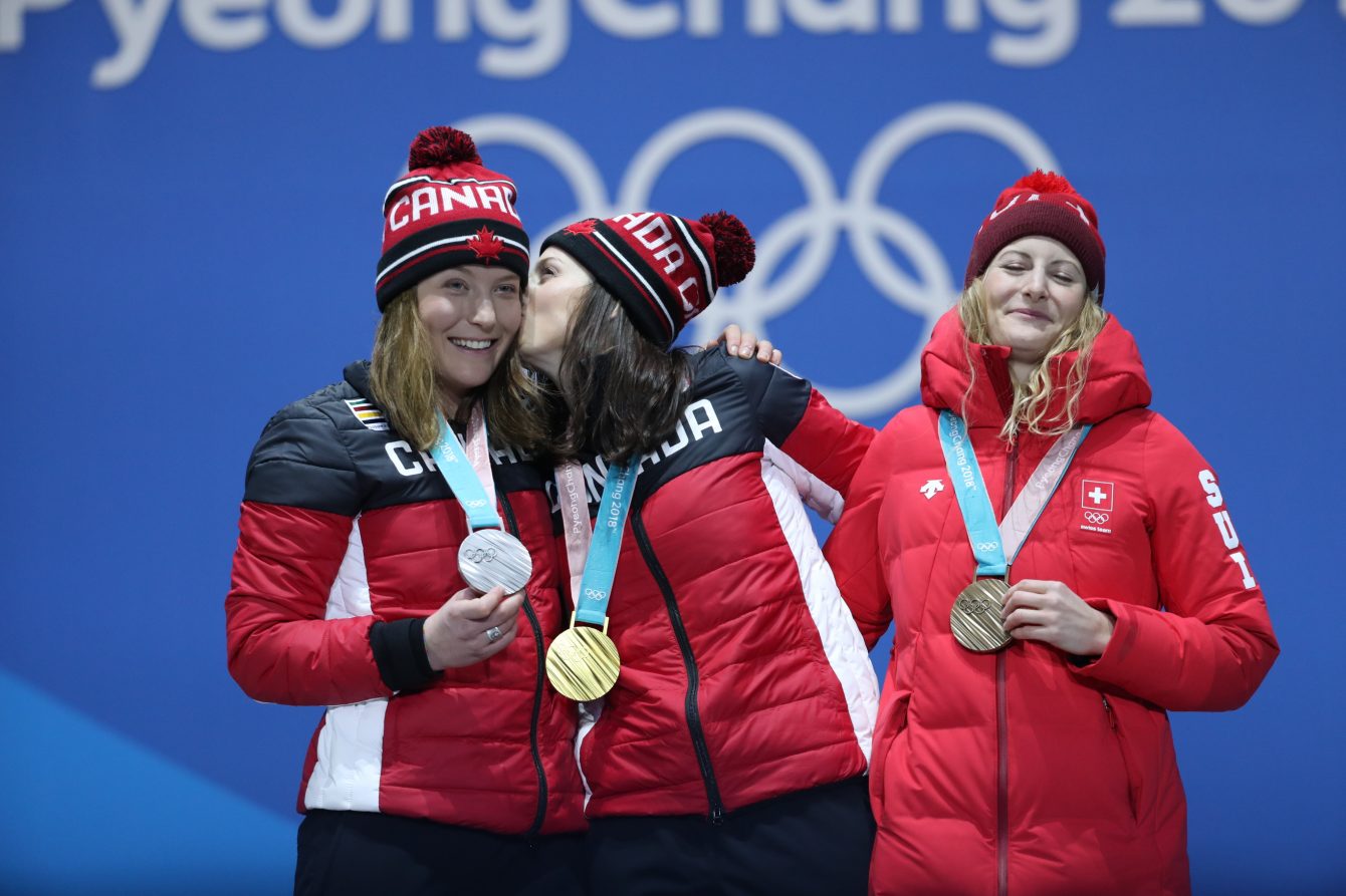 Canada's Kelsey Serwa and Brittany Phelan celebrate their gold and silver medals during a medal presentation ceremony at the PyeongChang 2018 Olympic Winter Games in Korea, Friday, February 23, 2018. Also pictured is bronze medalist Fanny Smith of Switzerland.<br /> THE CANADIAN PRESS/HO - COC Ð David Jackson