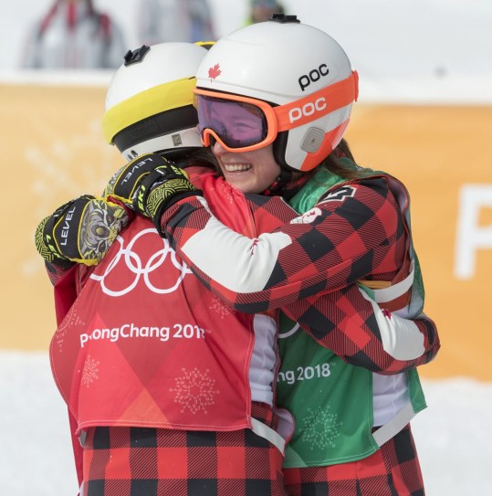 Canada's Kelsey Sherwa, red bib, celebrates with fellow Canadian Brittany Phelan after placing first and second in ski cross at the PyeongChang 2018 Olympic Winter Games in Korea, Friday, February 23, 2018. THE CANADIAN PRESS/HO - COC – Jason Ransom