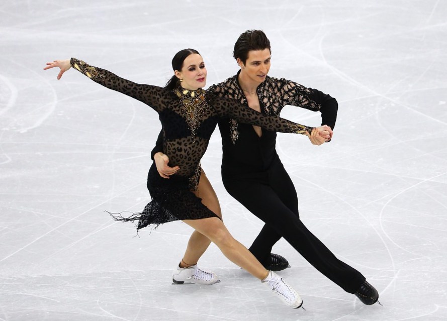 Tessa Virtue and Scott Moir in competition at the PyeongChang Games. Both are dressed in all black outfits.