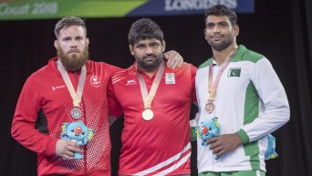 Team Canada's Korey Jarvis, silver left, Pakistan's Tayab Raza, gold center, and India's Sumit, bronze right, stand on the podium