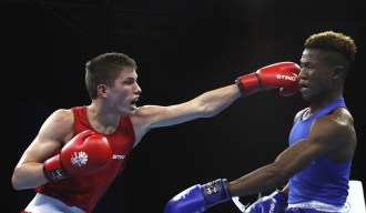 Two boxers fight in the ring