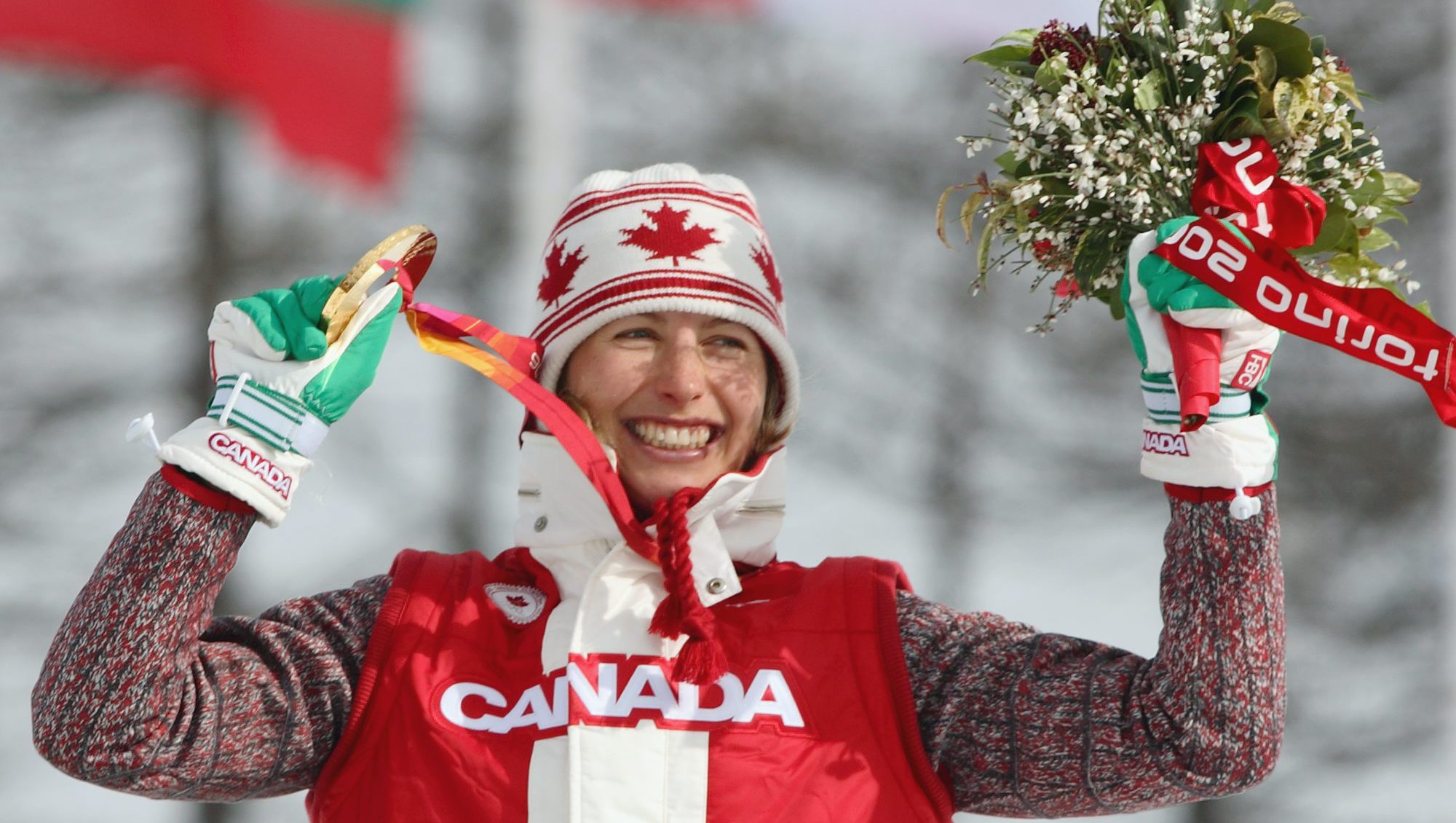 A Team Canada athlete poses with her medal