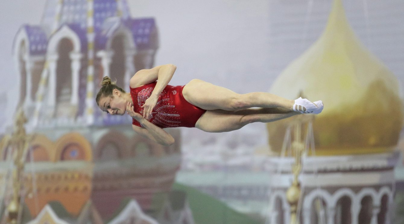 Rosie Maclennan horizontal & mid-air during a routine.