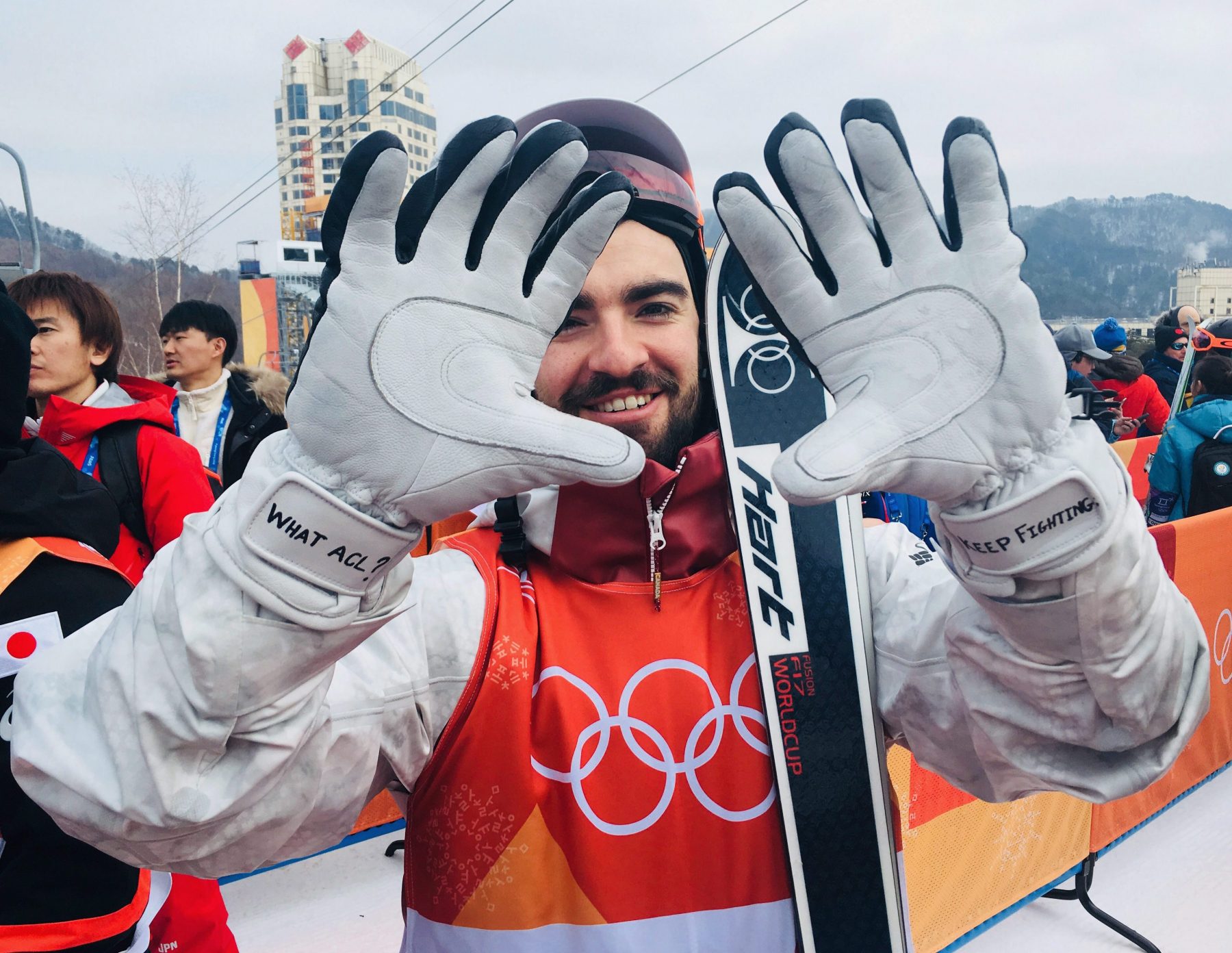 Skier holds up gloves to camera