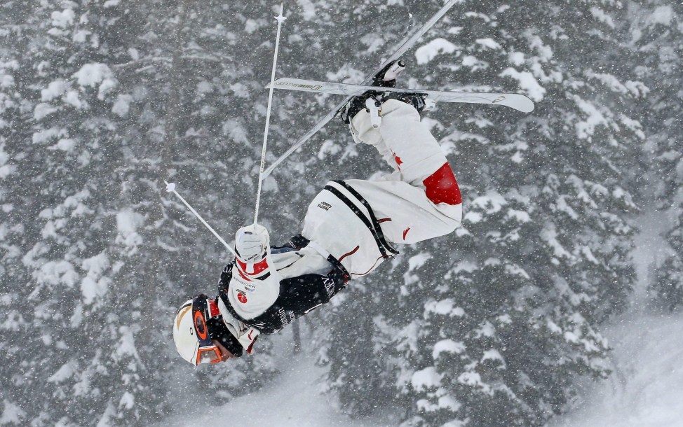 Mikael Kingsbury performs a jump in moguls
