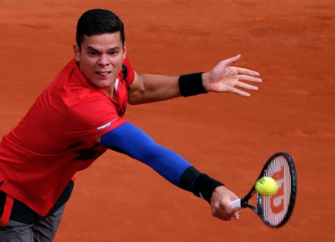 France Tennis French Open Milos Raonic backhands the ball