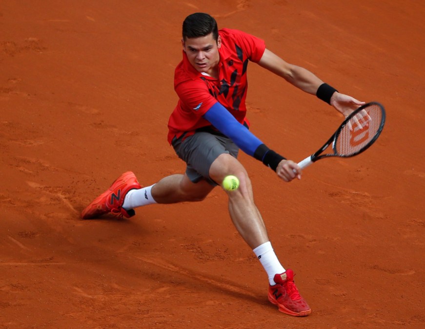 France Tennis French Open Milos Raonic backhands the ball
