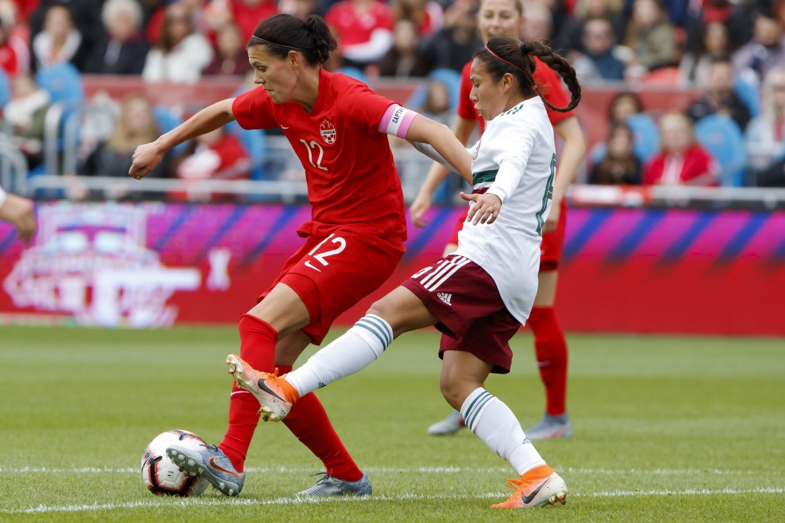 Team Canada captain Christine Sinclair tries to keep the ball away from Team Mexico midfielder Karla Nieto during the first half of a women's international soccer friendly at BMO Field in Toronto, Saturday, May 18, 2019. THE CANADIAN PRESS/Cole Burston