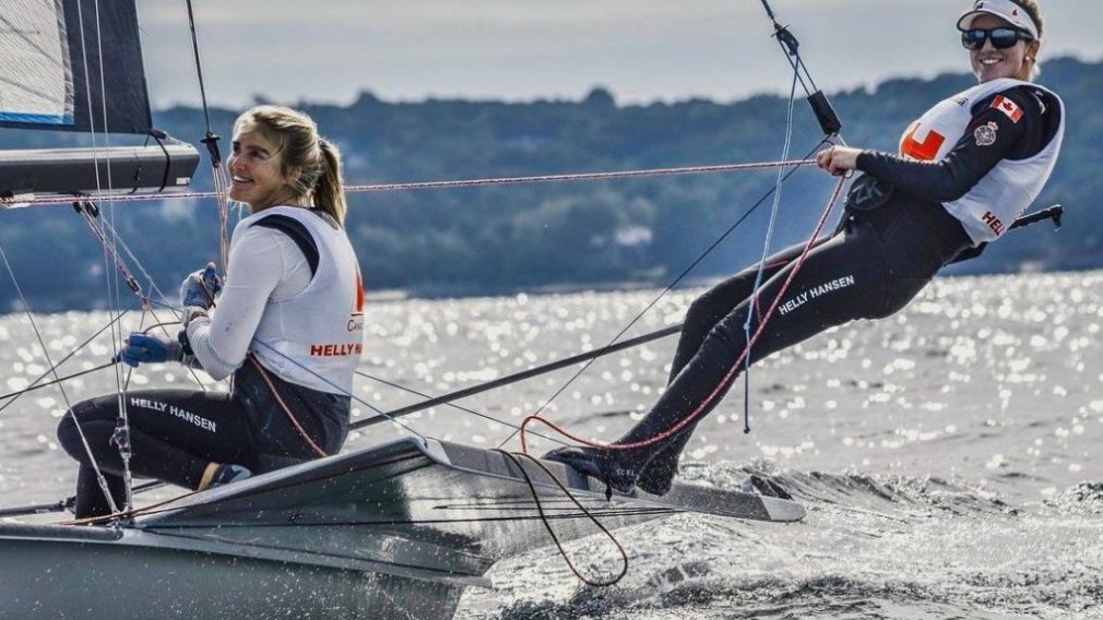 Ali Ten Hove and Mariah Millen smile while sailing.