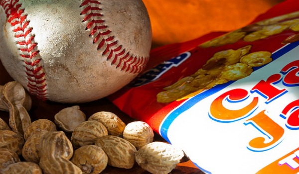 A bag of Cracker Jacks and peanuts and a baseball