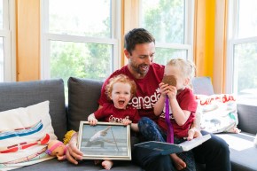 Father and children laughing on couch