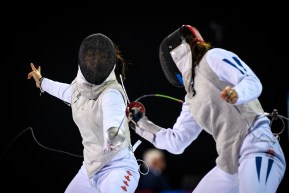 Jessica Guo (left) competes against Saskia van Erven Garcia of Columbia during the women's foil individual.