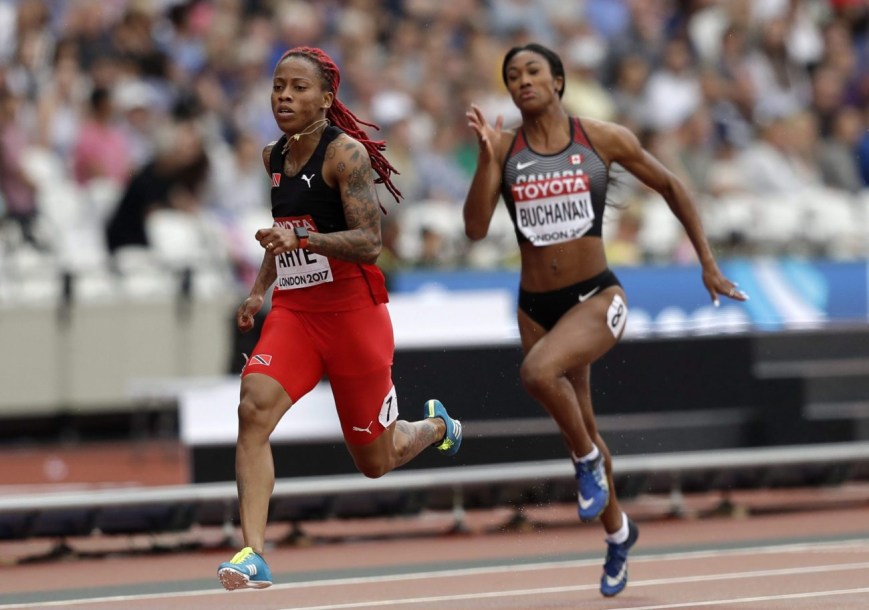 Leya Buchanan running beside Trinidad and Tobago's Michelle-Lee Ahye