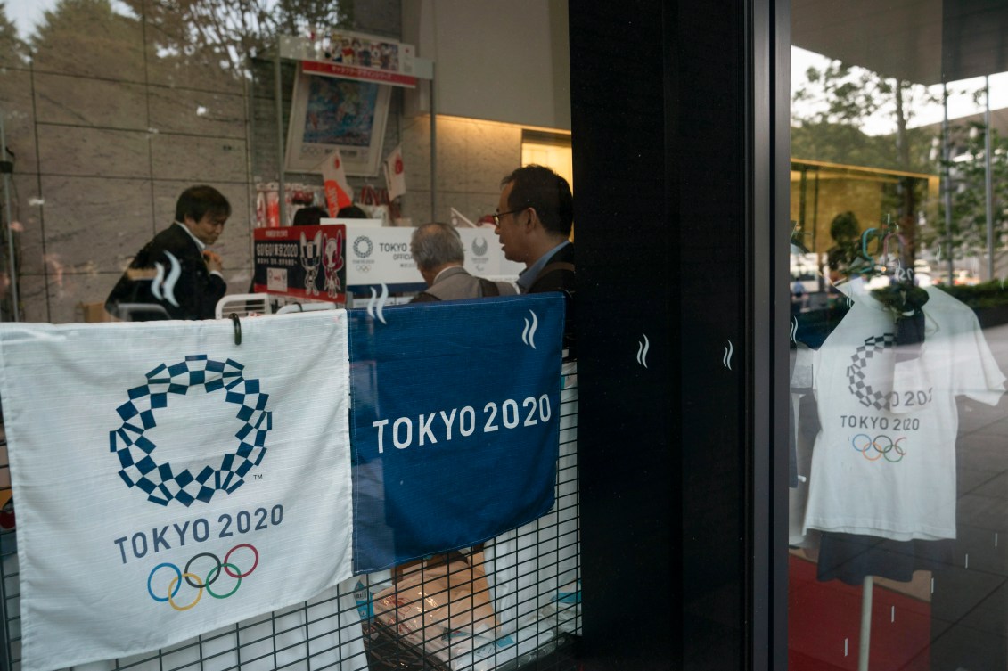 People shopping at a store selling Olympic souvenirs in Tokyo on June 19, 2019.