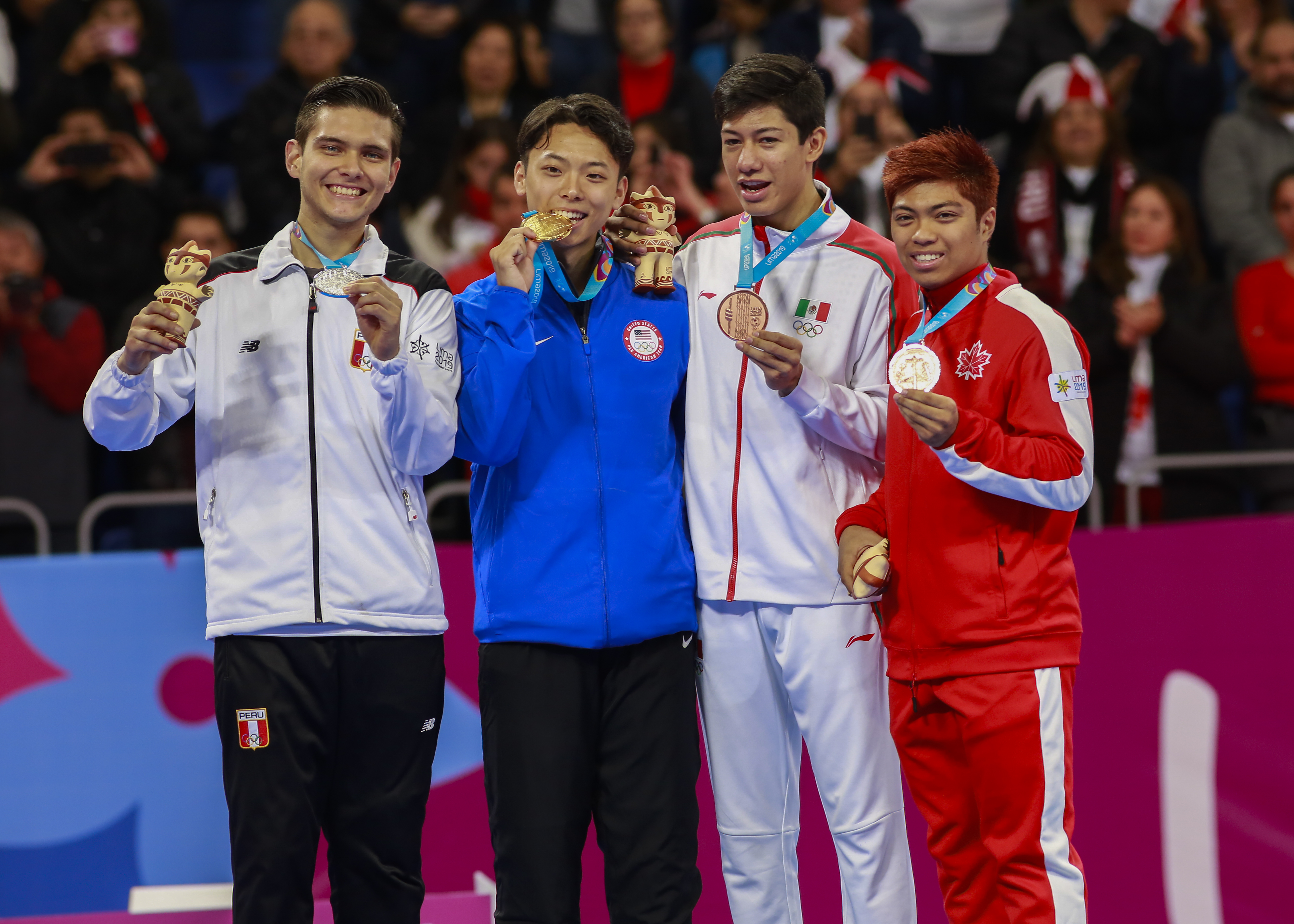 Hugo Castillo Peru ,left, holding the silver medal, Alex Lee from USA, the winner of the Taekwondo competition together with Marco Arroyo from Mexico and J. Abbas Assadian from Canada