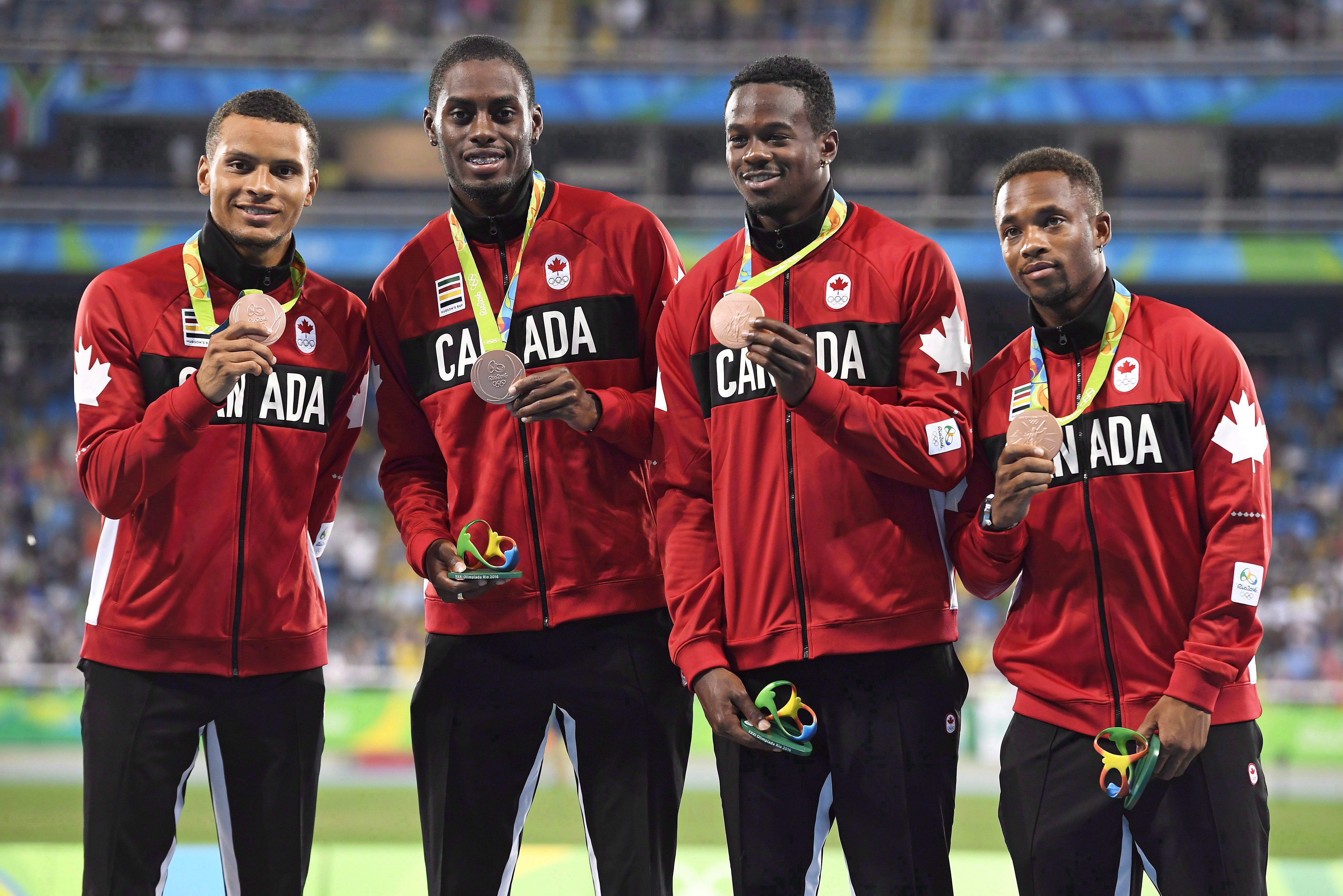 Akeem Haynes Aaron Brown, Brendon Rodney and Andre De Grasse pose with bronze medals on the podium