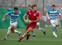Brennig Prevost evades Argentina players in men's rugby sevens gold medal action at the Pan Am Games