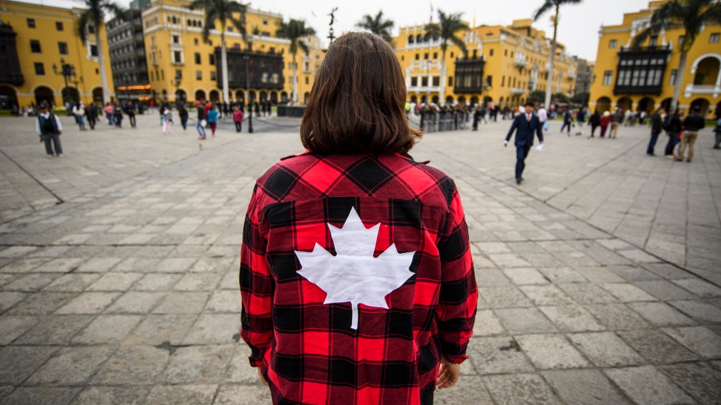 Woman with maple leaf flannel site seeing in Lima