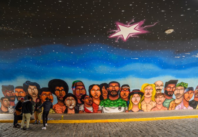 Street art showing locals starring at a star in the sky