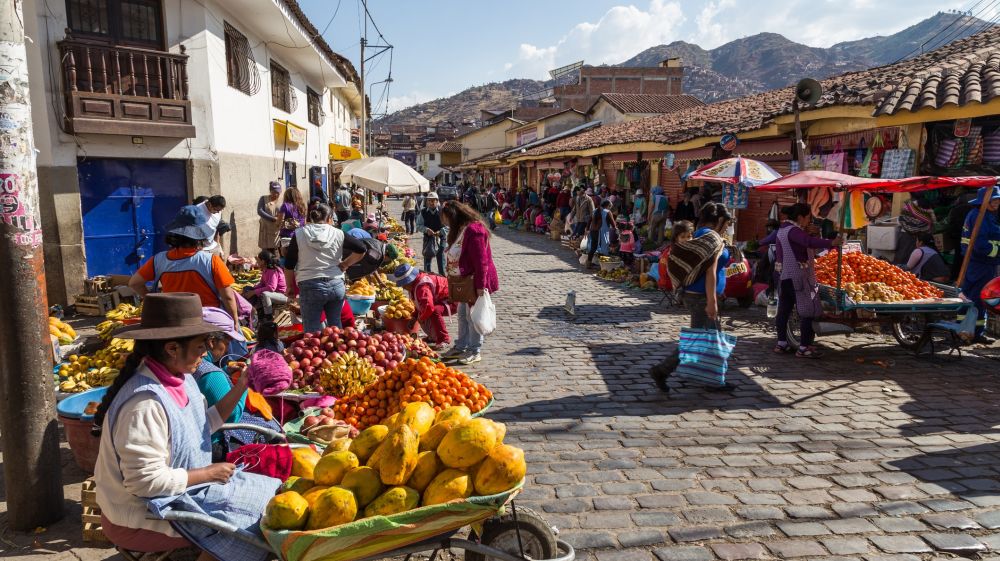 A busy street featuring many locals in the city of Cusco. 