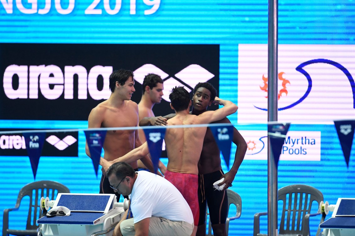 The men's 4x100m medley team embraces after the race.