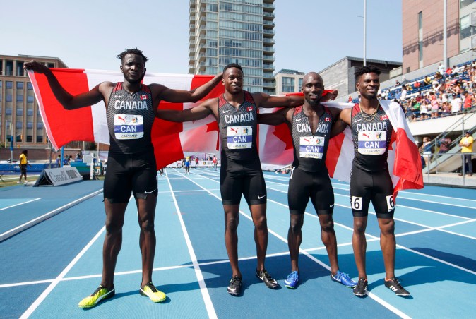 Sprinters pose with the Canadian flag