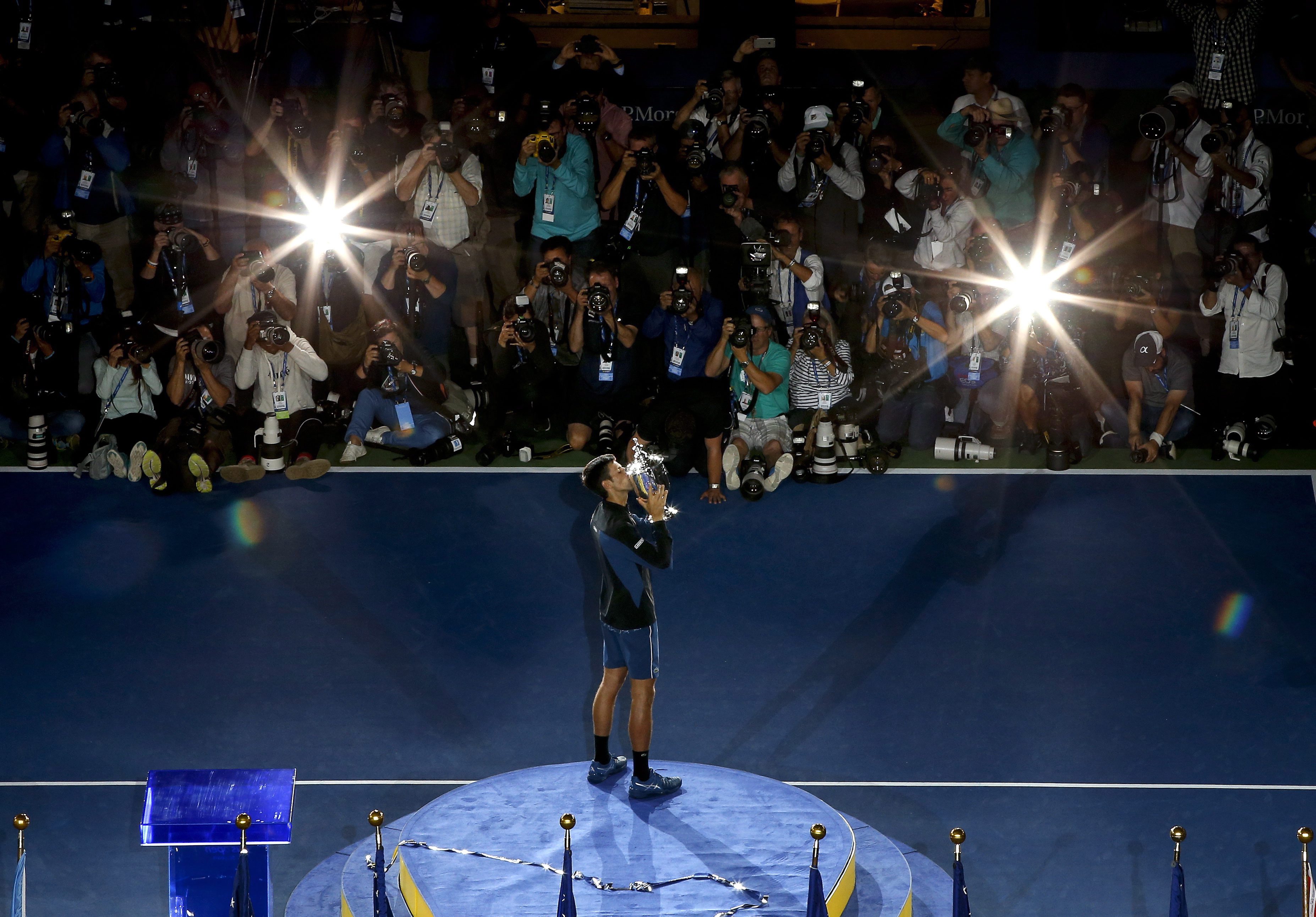 Novak Djokovic kisses the US Open trophy