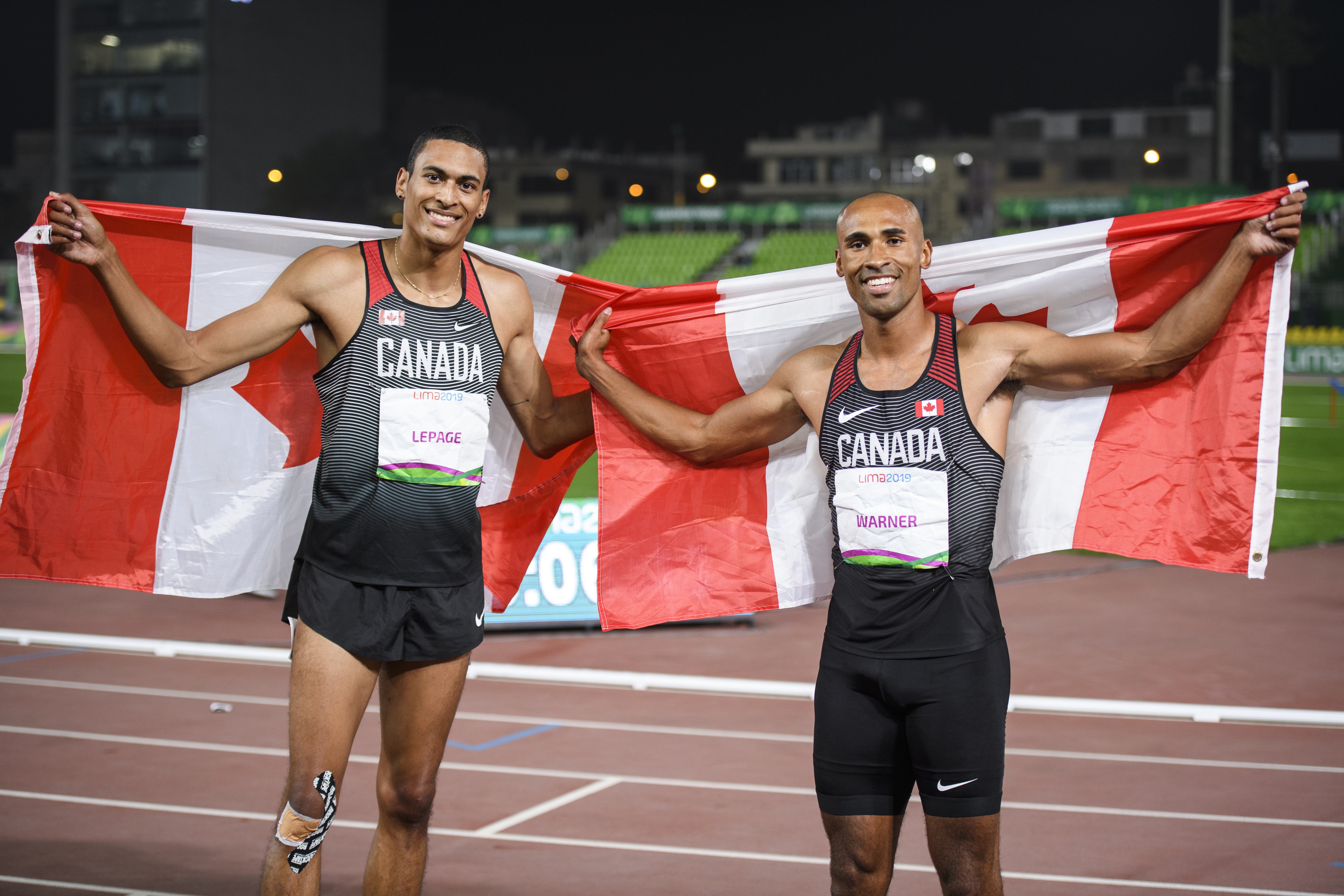 Pierce Lepage and Damian Warner take photo with Canadian flag