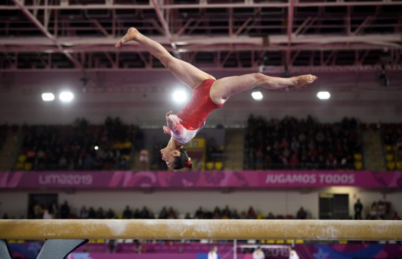 gymnast does a backflip on beam