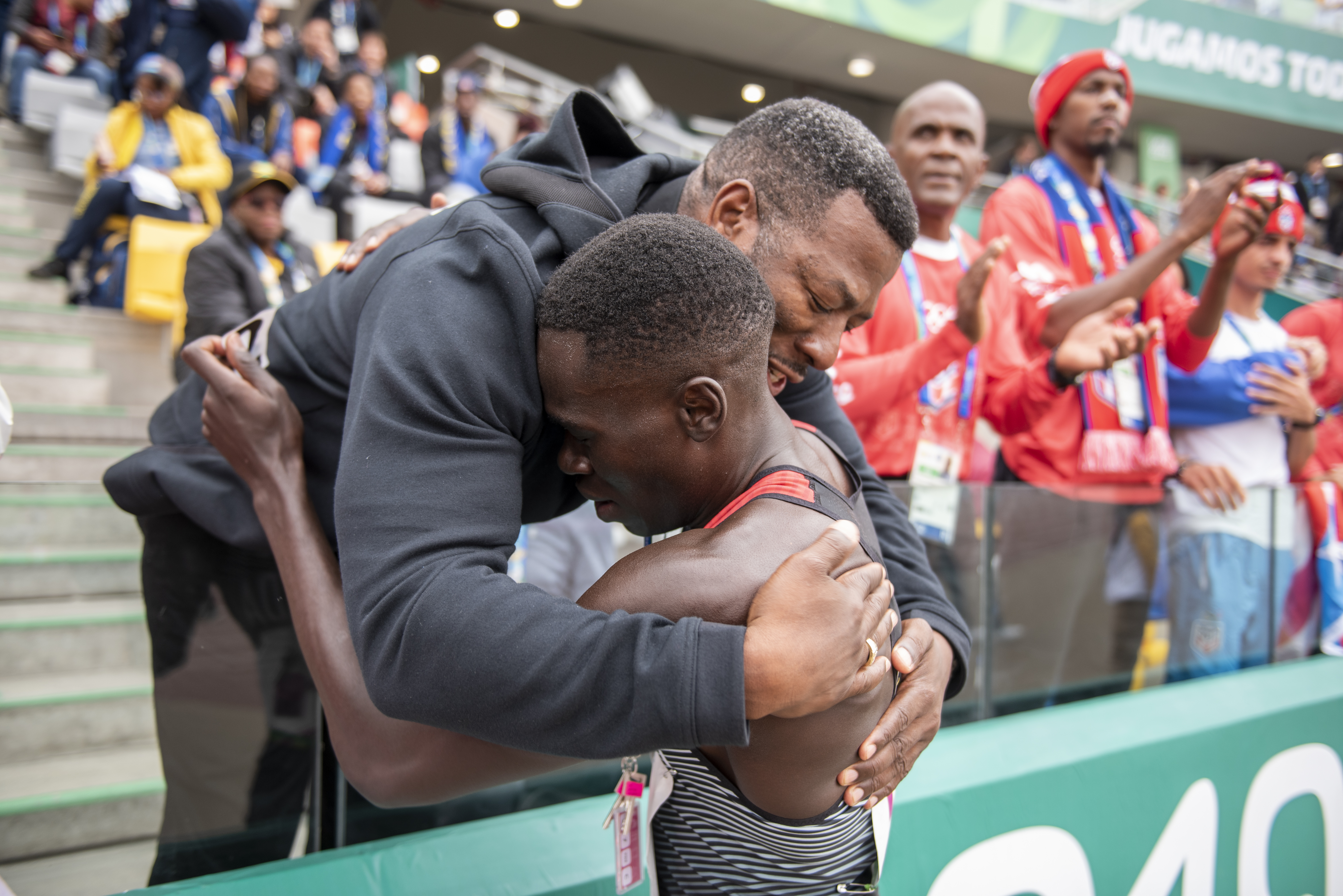Marco Arop hugs his coach