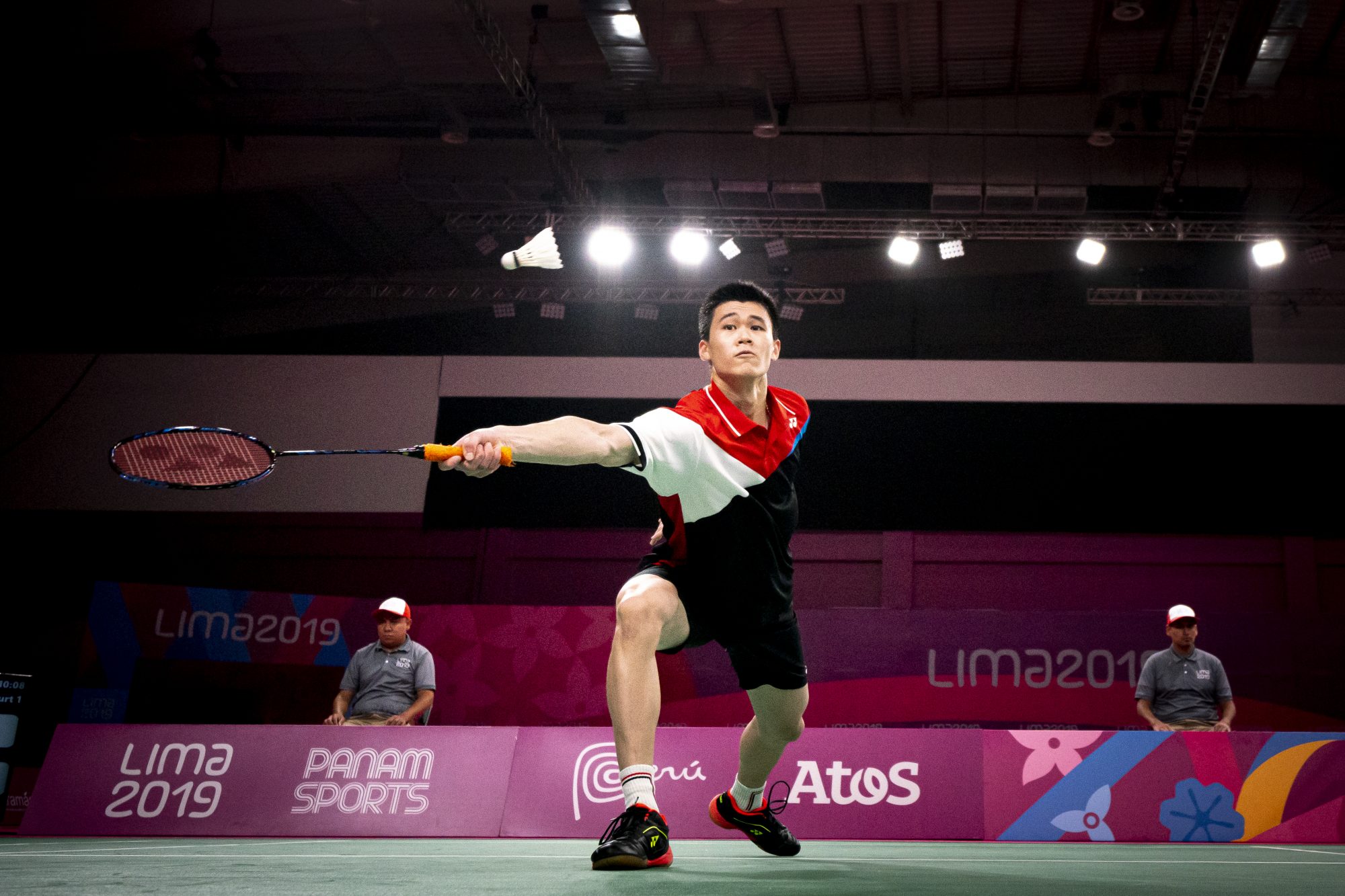 badminton player reaches for the birdie