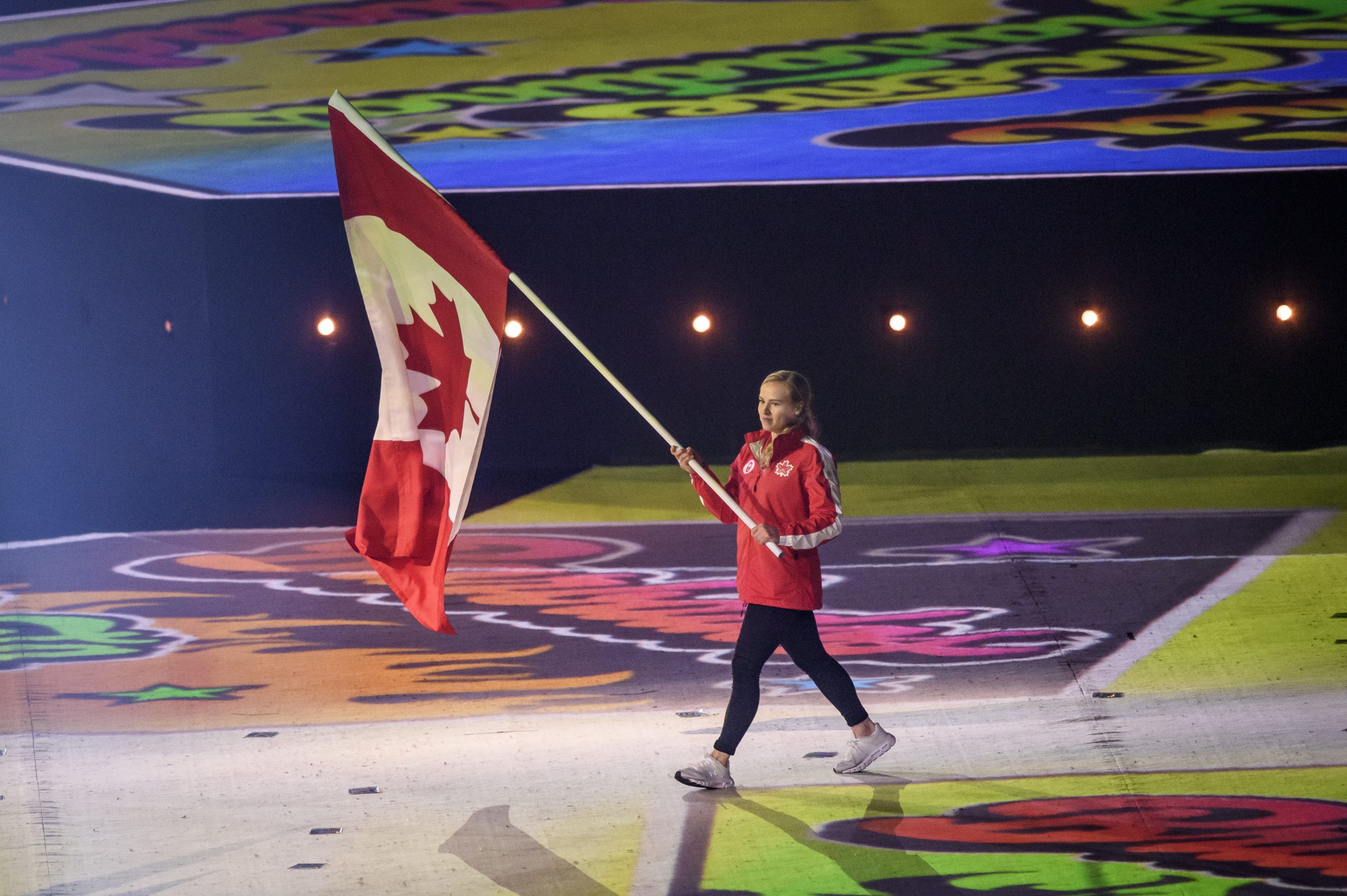 ellie black carrying the canadian flag