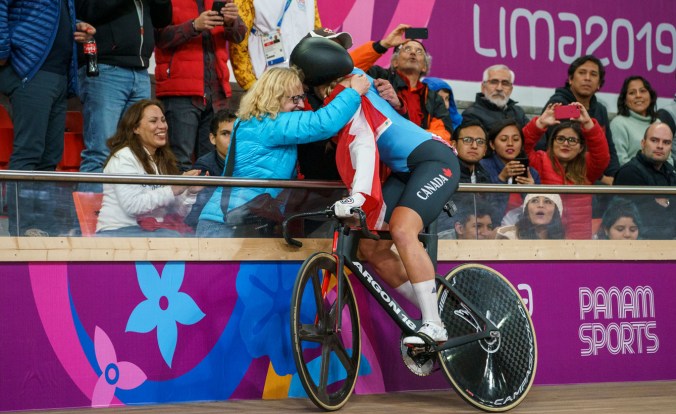Kelsey hugs her parents after winning Lima 2019 gold
