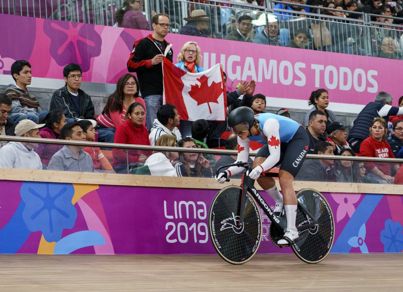 Kelsey Mitchell's parents, cheer her on holding a Canadian flag during women sprint