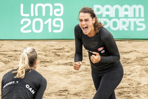 athlete celebrates a point in beach volleyball