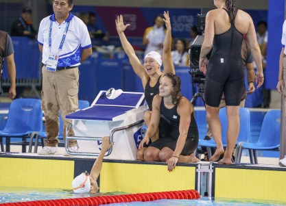 four swimmers celebrate