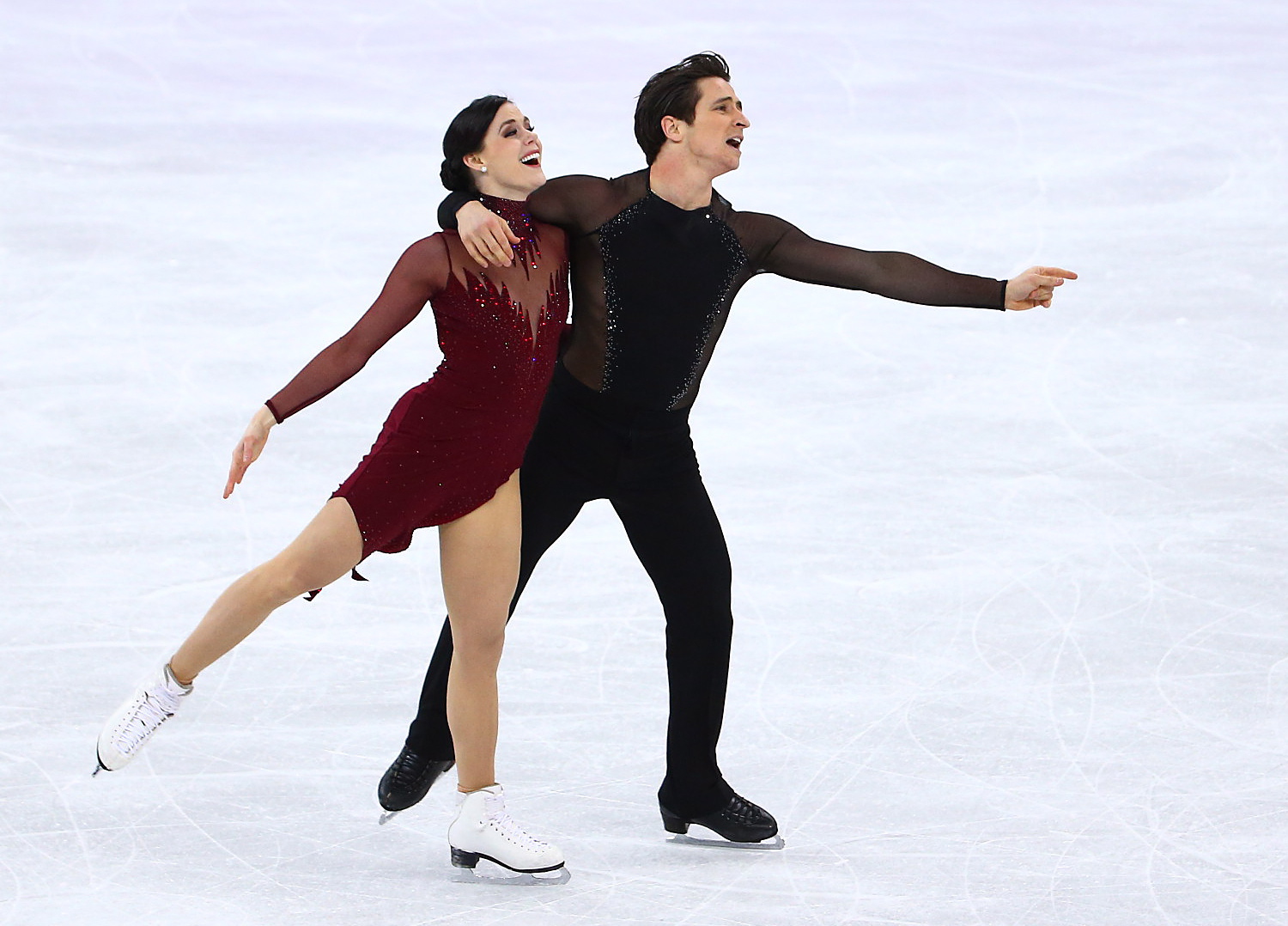 Tessa Virtue and Scott Moir skating during their gold medal Olympic performance.