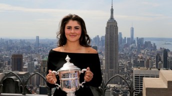 Bianca holds US Open Trophy in front of skyline