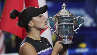 Bianca Andreescu, of Canada, kisses the championship trophy