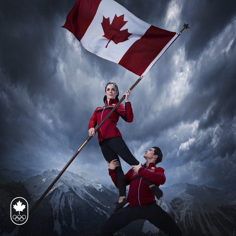 Tessa and Scott holding the Canadian flag for the torchbearer picture