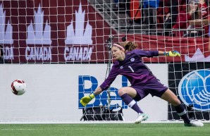 Goalkeeper Stephanie Labbé stretches out to dive for a shot coming her way.