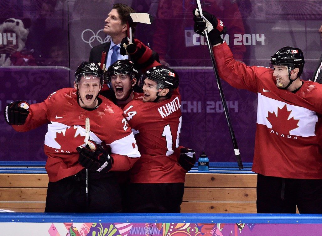 Team Canada's Olympic 2014 hockey team cheers on the bench.