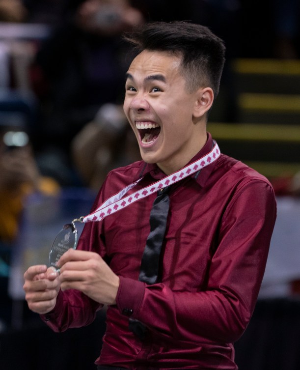 Nam Nguyen smiles as he holds his silver medal
