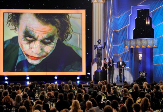 Gary Oldman accepts an award for Heath Ledger