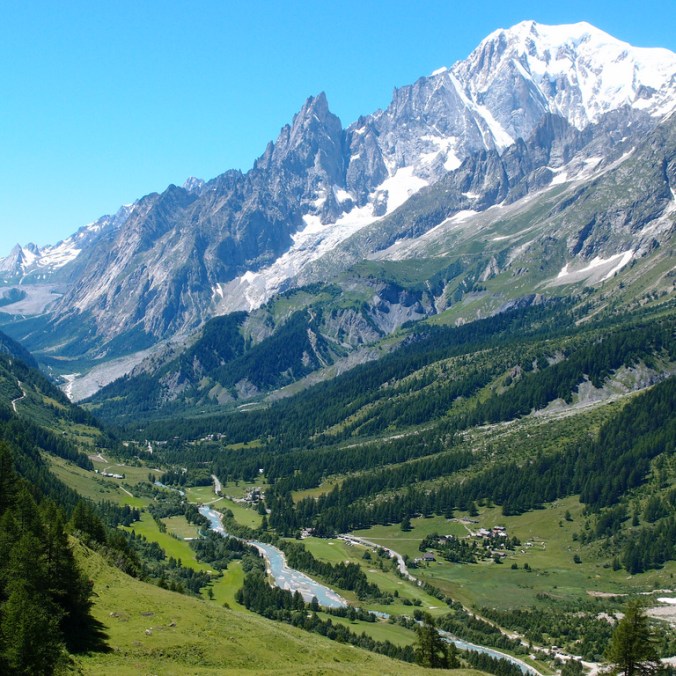Scenic view of Mont Blanc mountains over greenery.