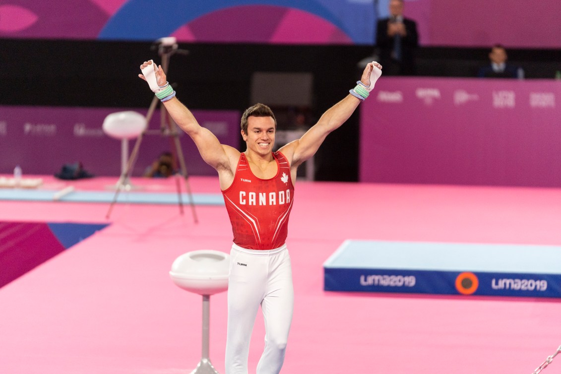 Rene Cournoyer competing in horizontal bars