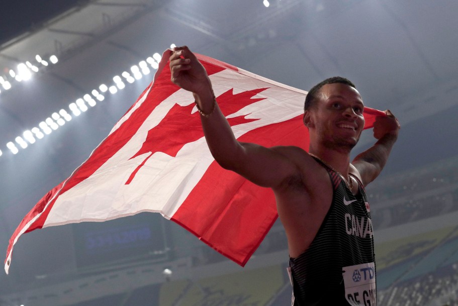 Andre de Grasse holding Canadian flag