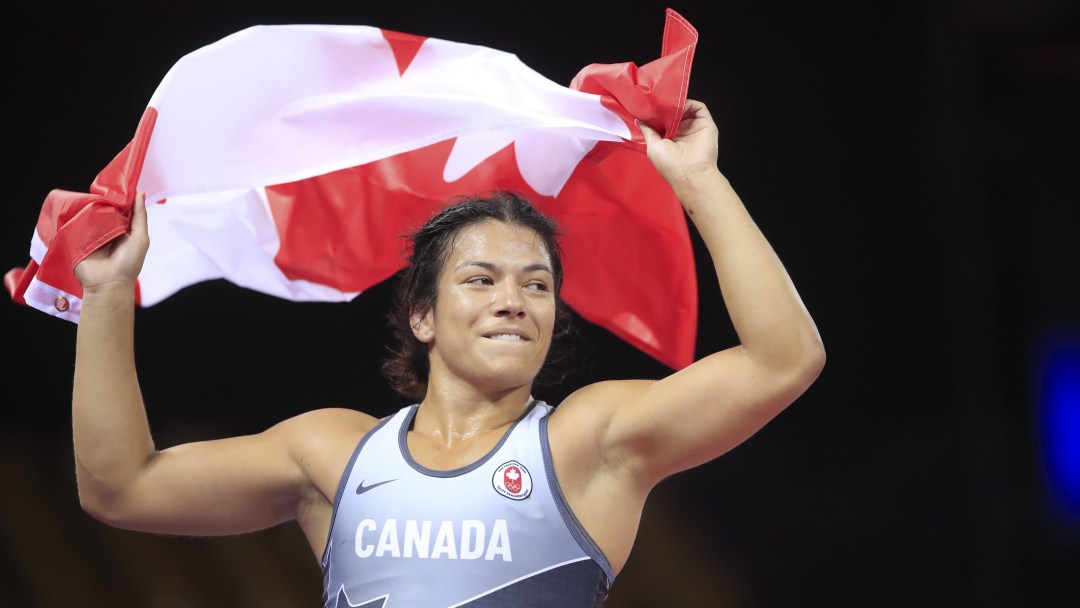 Justina holds the Canadian flag above her head.